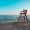 Mediterranean beach with wooden lifeguard chair in sunset time, Oliva Beach in Valencia province, Spain. Teal and orange style.